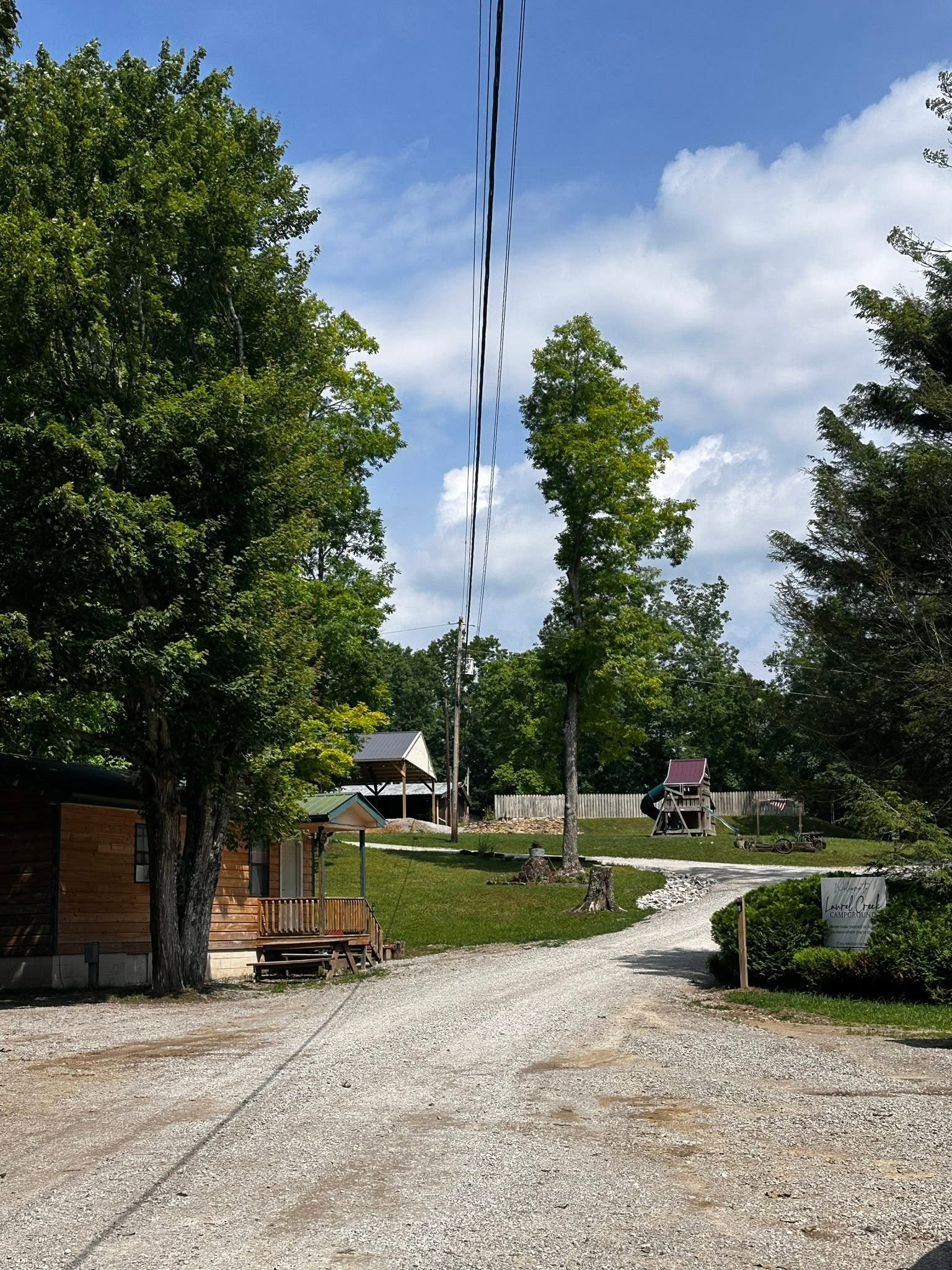 Cabin and wooded entrance at Laurel Creek Campground