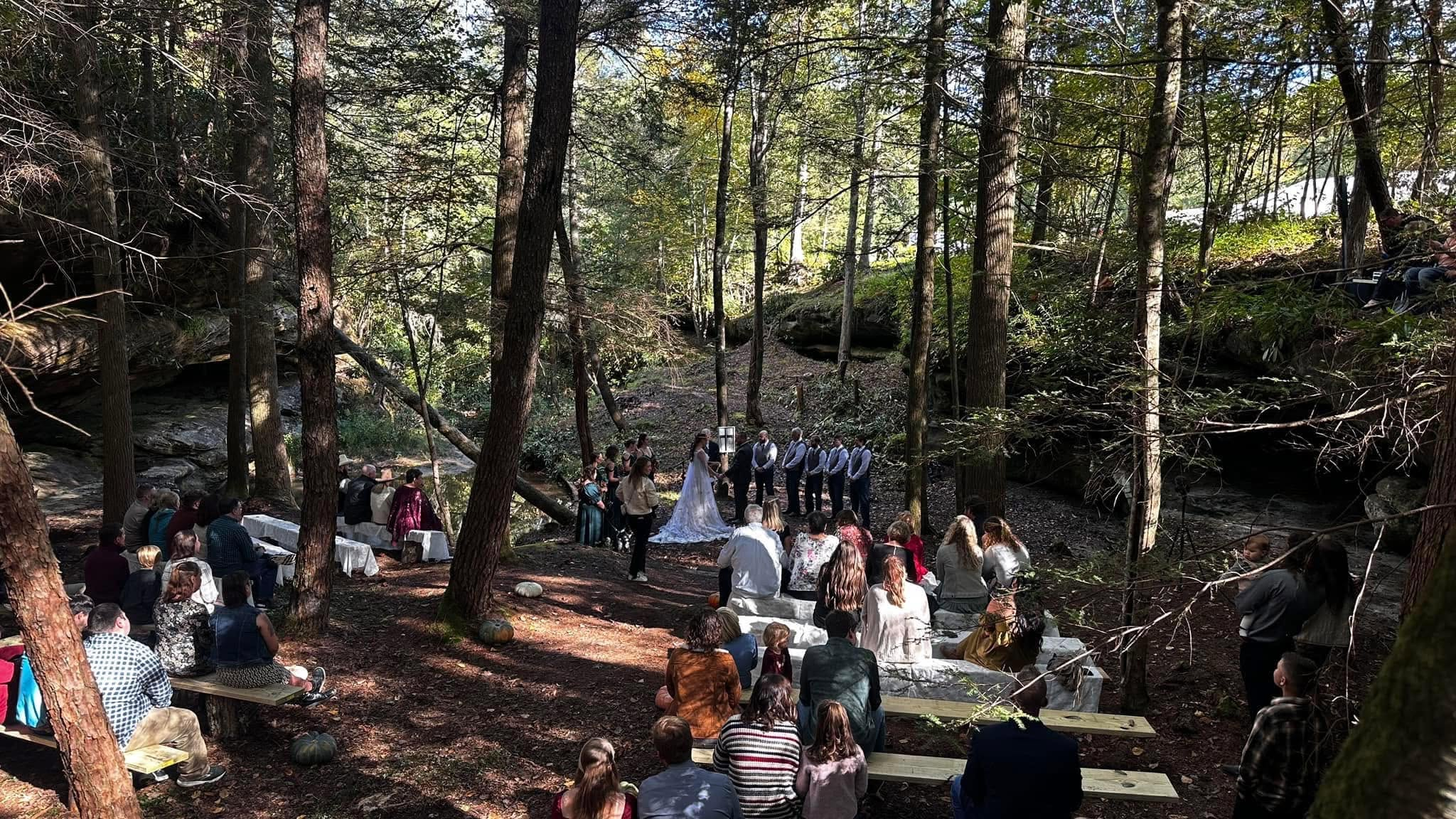 An outdoor wedding ceremony surrounded by woodland at Laurel Creek Campground