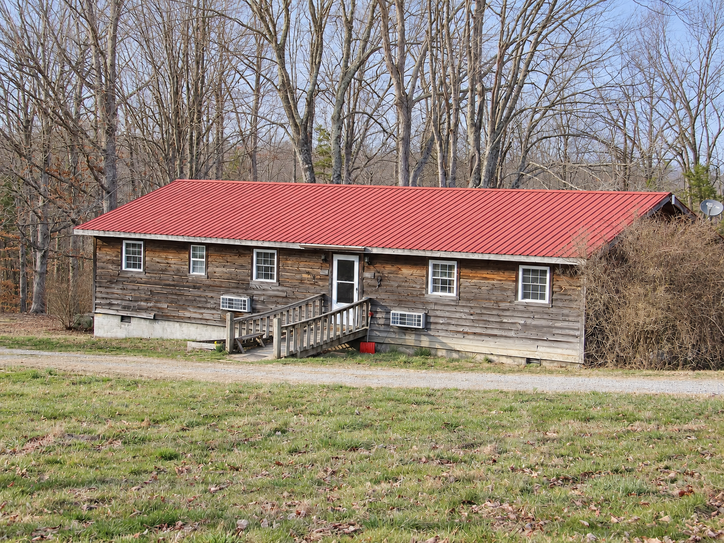 Wood-sided duplex cabin with a red roof at Laurel Creek